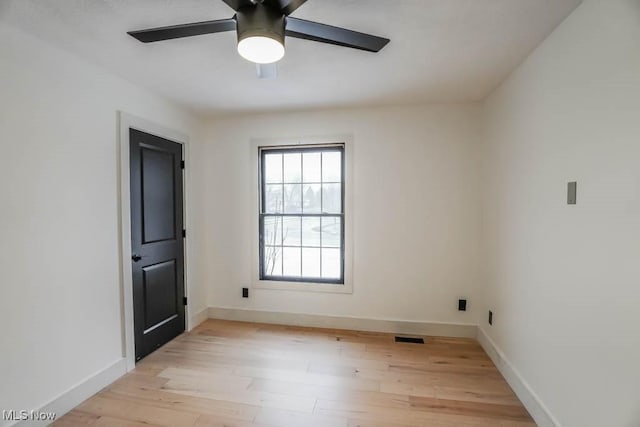 empty room featuring ceiling fan and light wood-type flooring