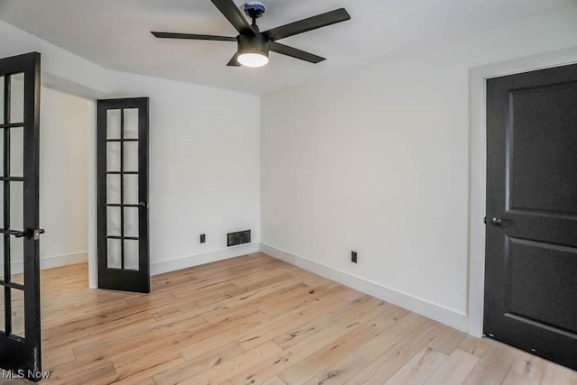 unfurnished room with french doors, ceiling fan, and light hardwood / wood-style flooring