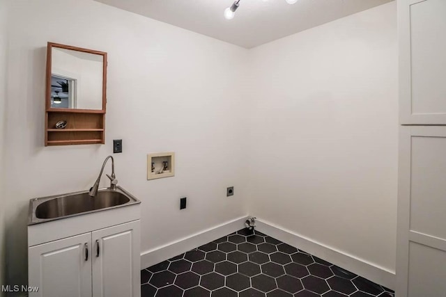 washroom with cabinets, washer hookup, sink, and hookup for an electric dryer