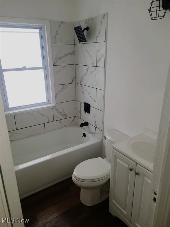 full bathroom with hardwood / wood-style floors, vanity, toilet, and tiled shower / bath combo