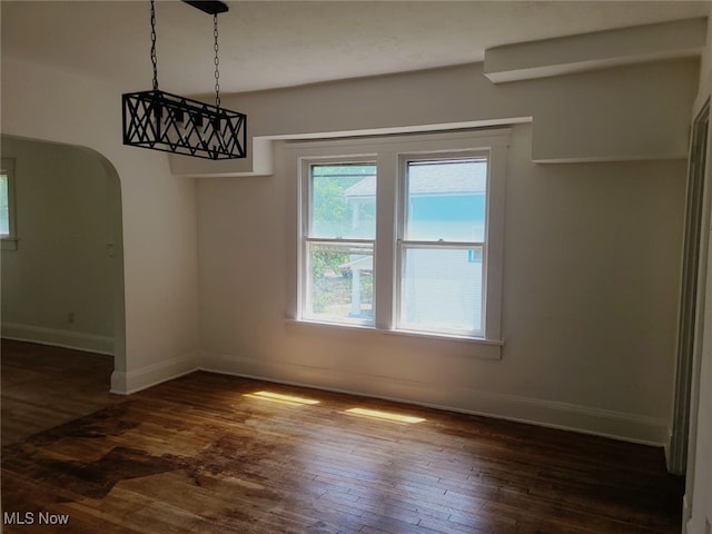 unfurnished dining area featuring dark hardwood / wood-style flooring and a wealth of natural light