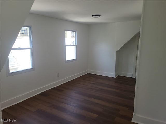 empty room with dark hardwood / wood-style flooring