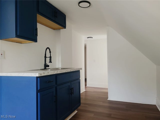 kitchen with dark hardwood / wood-style flooring, sink, and blue cabinets