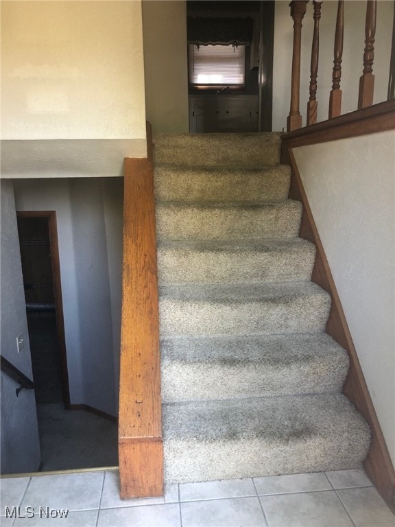 stairs featuring tile patterned flooring