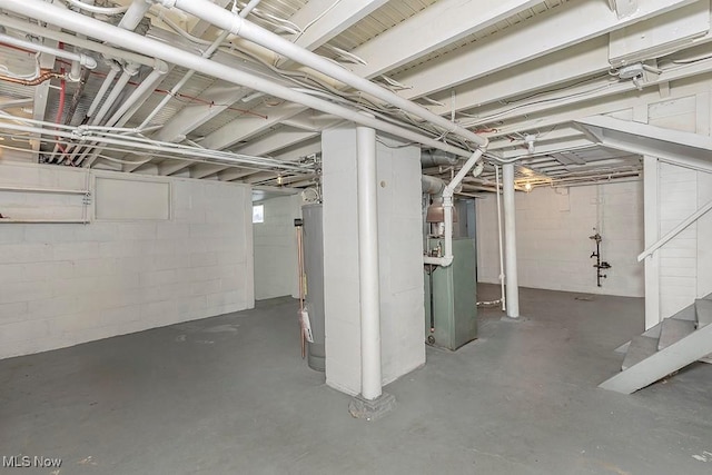 basement featuring heating unit and water heater