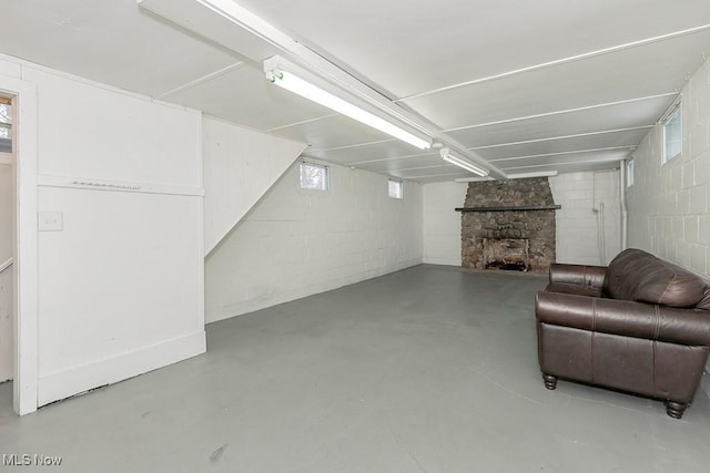 basement with a stone fireplace