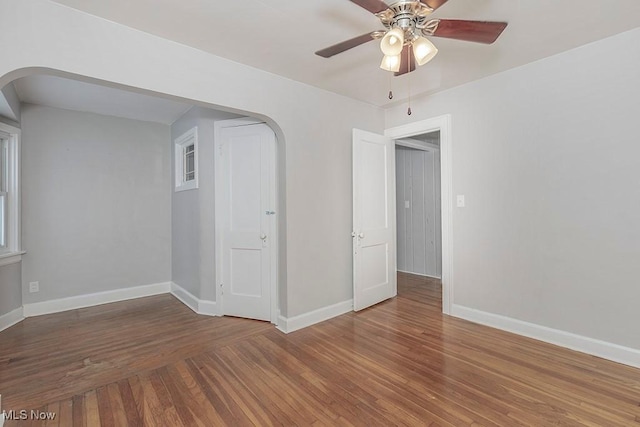 spare room featuring ceiling fan and dark hardwood / wood-style flooring