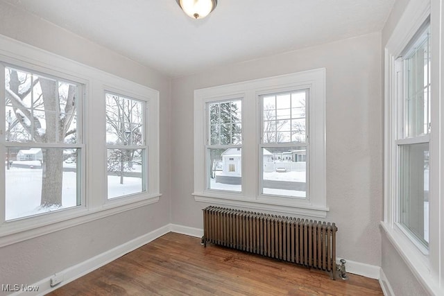 unfurnished sunroom with radiator and a wealth of natural light