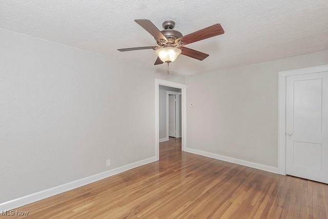 empty room with hardwood / wood-style floors, a textured ceiling, and ceiling fan