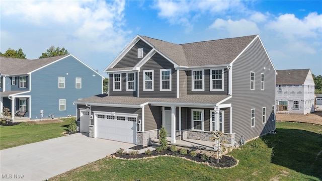 view of front of house with covered porch, a garage, and a front lawn