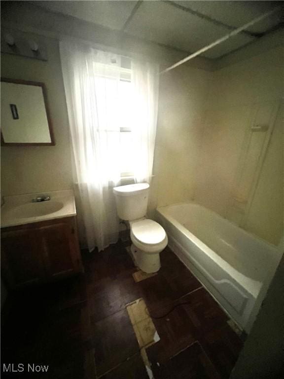 full bathroom with vanity, toilet, and washtub / shower combination