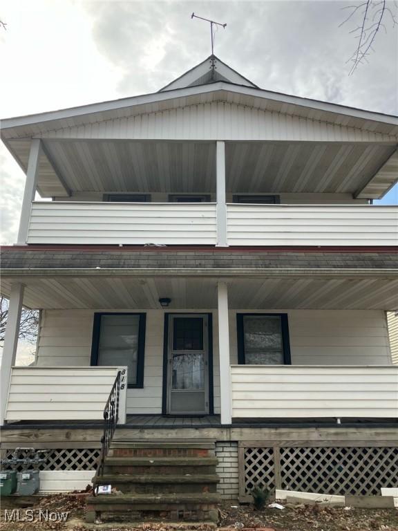 view of front of house featuring a balcony and a porch