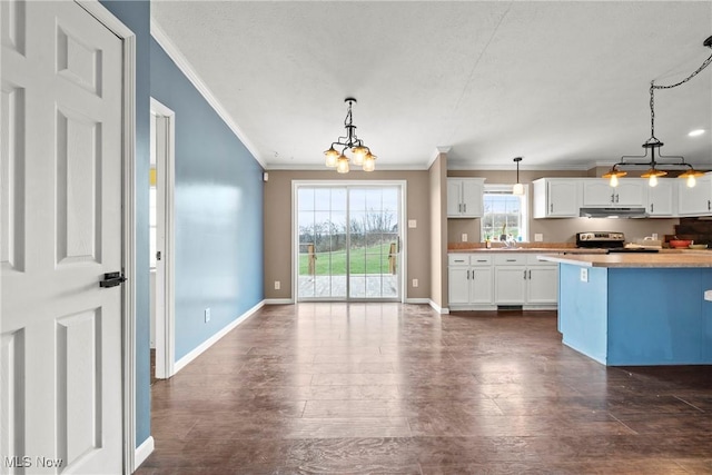 kitchen with white cabinets, electric range, a chandelier, and hanging light fixtures