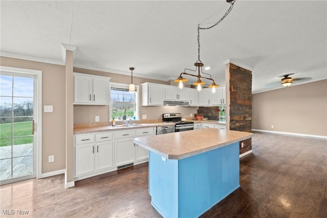 kitchen with ceiling fan, white cabinets, pendant lighting, a kitchen island, and appliances with stainless steel finishes