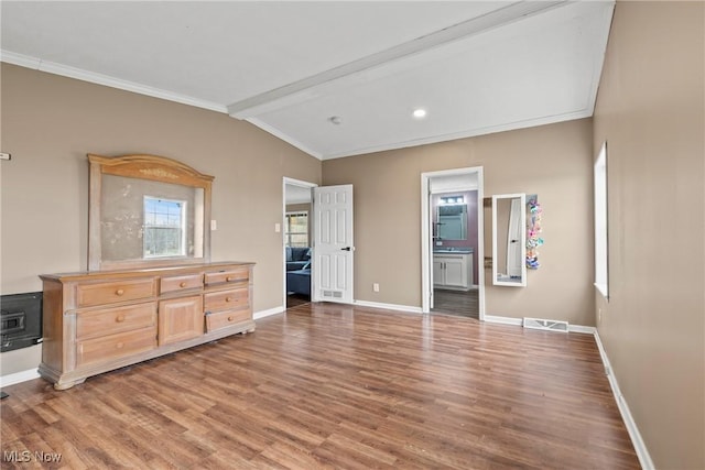 bedroom featuring wood-type flooring, crown molding, connected bathroom, and vaulted ceiling