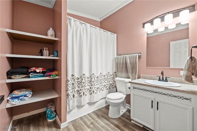 full bathroom with vanity, shower / bath combo with shower curtain, crown molding, hardwood / wood-style floors, and toilet