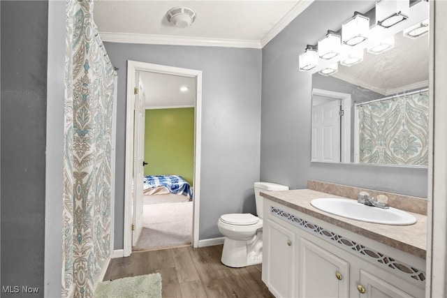 bathroom with vanity, crown molding, hardwood / wood-style floors, toilet, and lofted ceiling