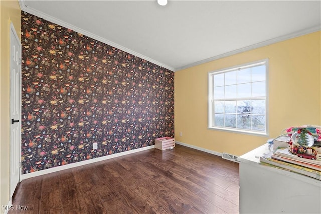 empty room featuring dark hardwood / wood-style flooring and ornamental molding