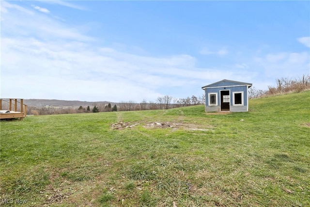 view of yard with an outbuilding and a rural view