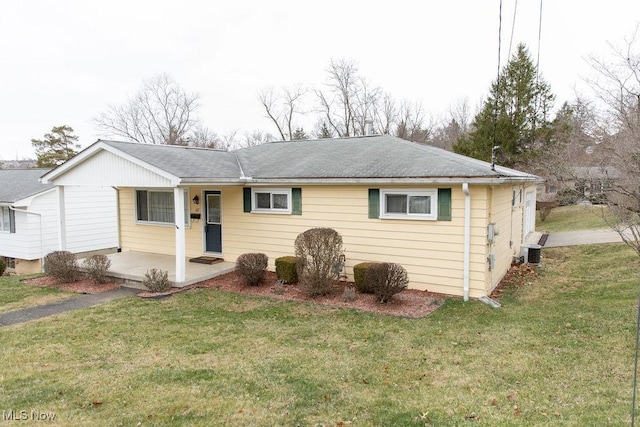 ranch-style home featuring a front yard and central AC unit