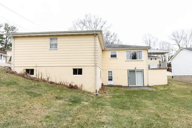 rear view of property with a lawn