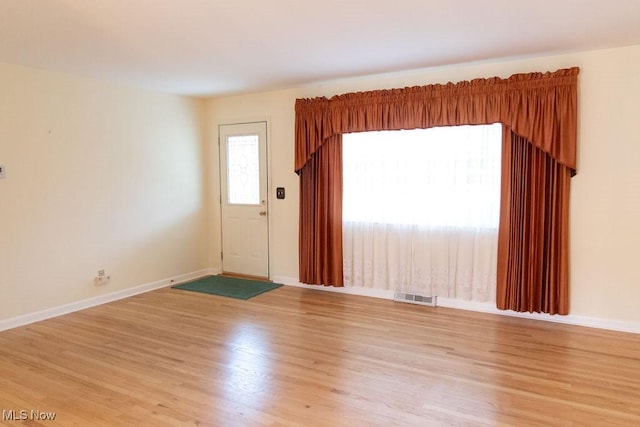 empty room with light hardwood / wood-style floors