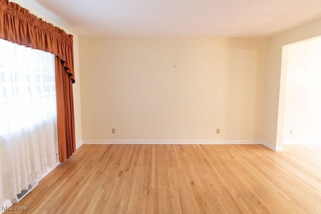 unfurnished room featuring light hardwood / wood-style floors