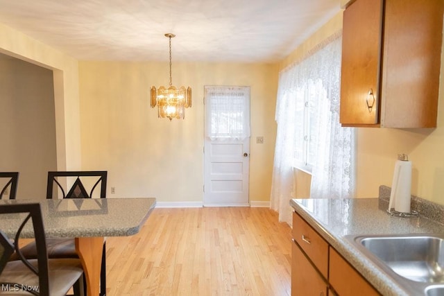 kitchen featuring a chandelier, light hardwood / wood-style floors, and decorative light fixtures