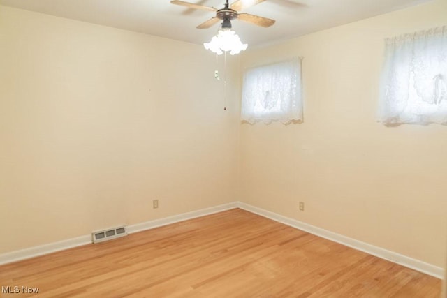 spare room with hardwood / wood-style floors and ceiling fan