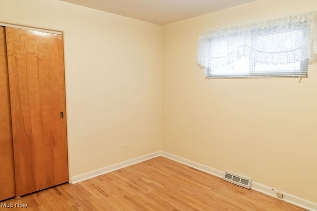 unfurnished room featuring hardwood / wood-style flooring