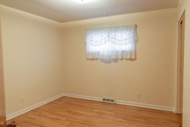 empty room featuring hardwood / wood-style flooring