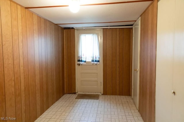 entryway featuring wood walls