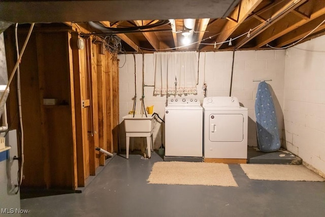 basement with washing machine and dryer and sink