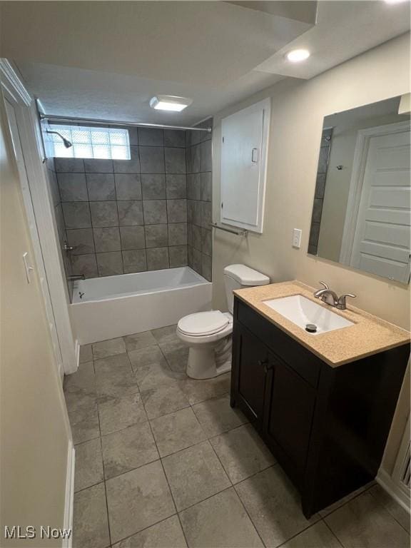 full bathroom featuring tile patterned floors, vanity, toilet, and tiled shower / bath