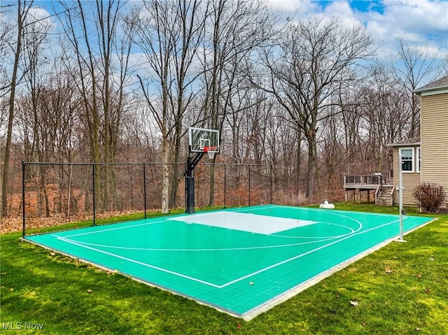 view of sport court with a yard