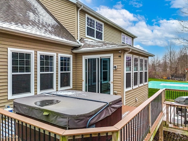 wooden terrace featuring a hot tub