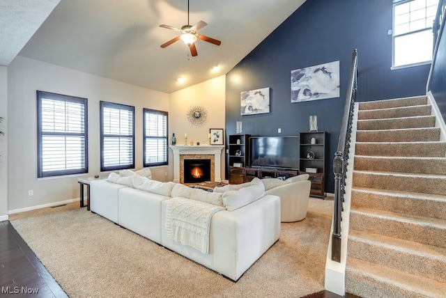 living room with ceiling fan, wood-type flooring, and vaulted ceiling