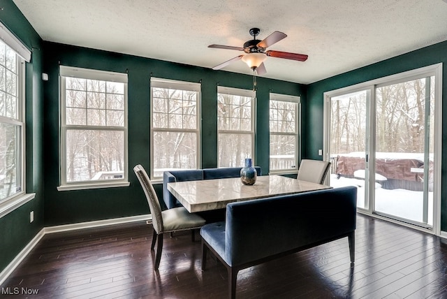 dining area featuring a wealth of natural light, a textured ceiling, dark hardwood / wood-style floors, and ceiling fan