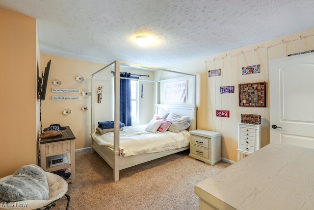 bedroom with a textured ceiling and light carpet