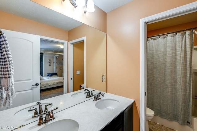 bathroom featuring tile patterned flooring, vanity, and toilet