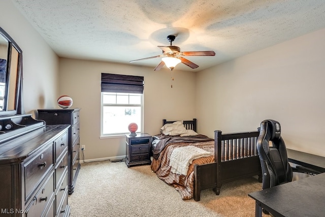 carpeted bedroom featuring a textured ceiling and ceiling fan