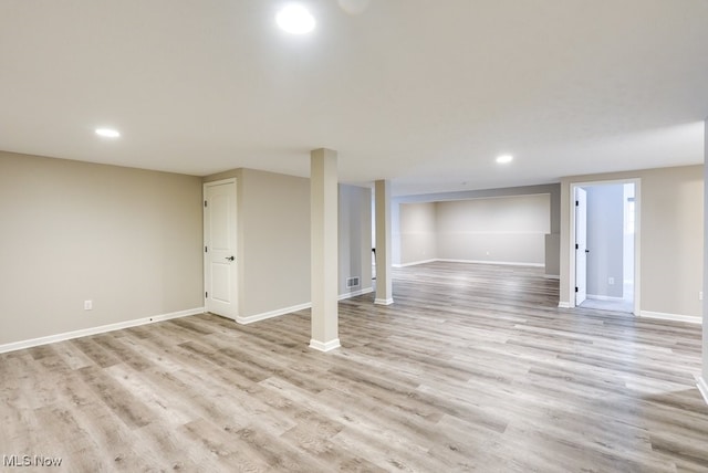 basement with light hardwood / wood-style floors