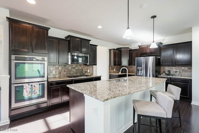 680 Morgan Trl, Aurora, OH 44202 - kitchen featuring light stone countertops, a sink, tasteful backsplash, appliances with stainless steel finishes, and dark wood-style floors