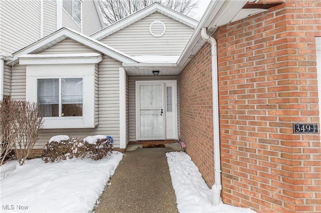 view of snow covered property entrance