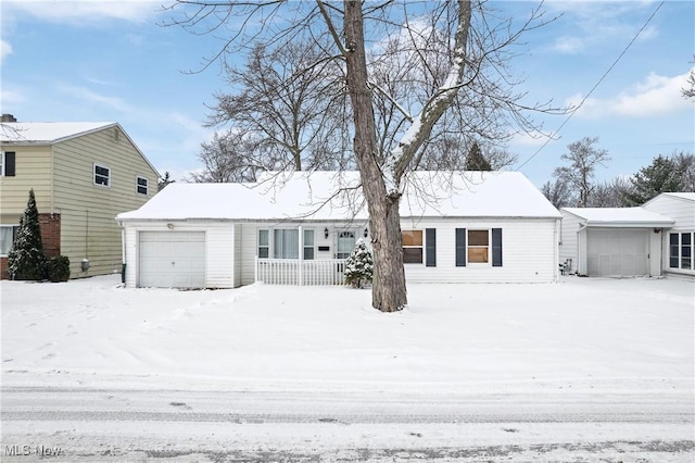 view of front facade featuring a porch and a garage