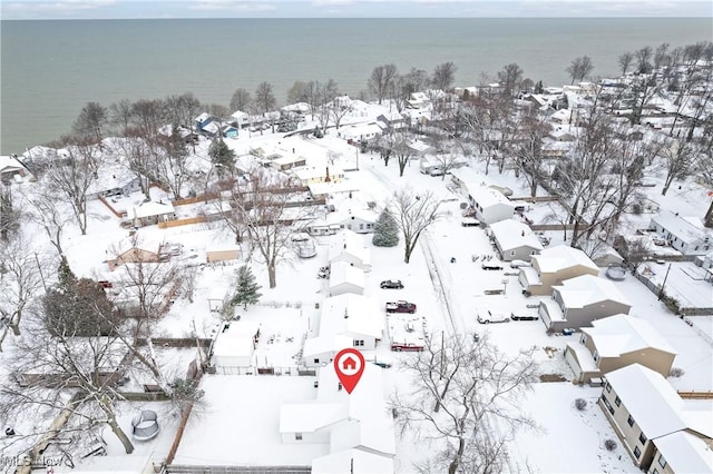 snowy aerial view with a water view