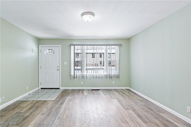 foyer entrance with light wood-type flooring