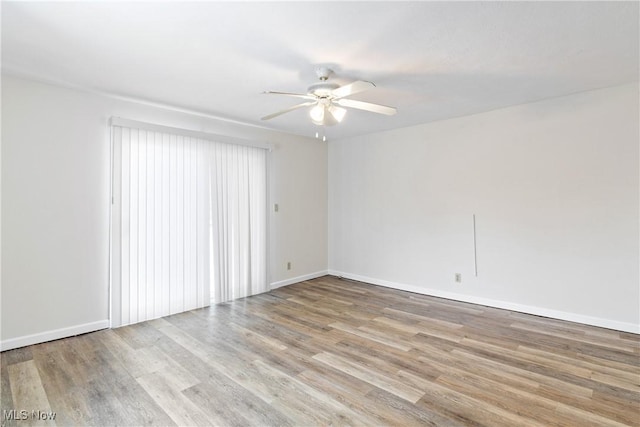 unfurnished room with light wood-type flooring and ceiling fan