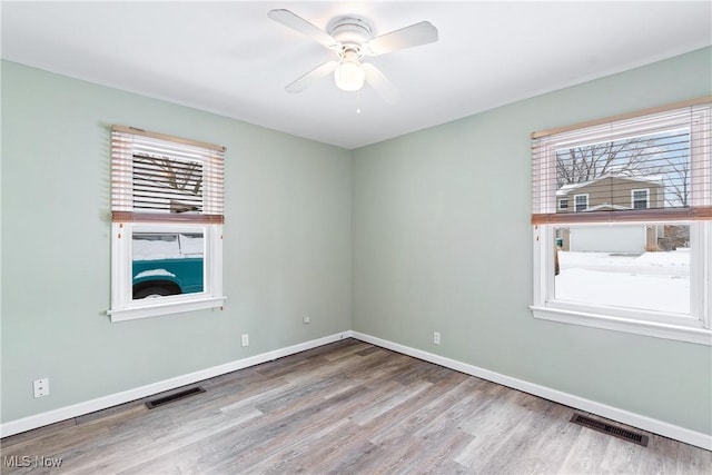 empty room featuring ceiling fan and light hardwood / wood-style floors