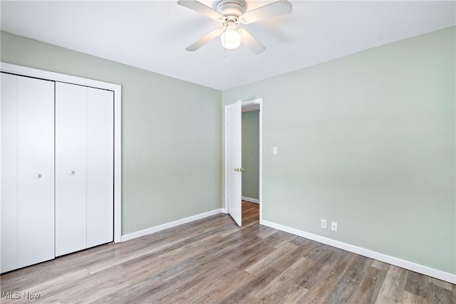 unfurnished bedroom with ceiling fan, light hardwood / wood-style floors, and a closet